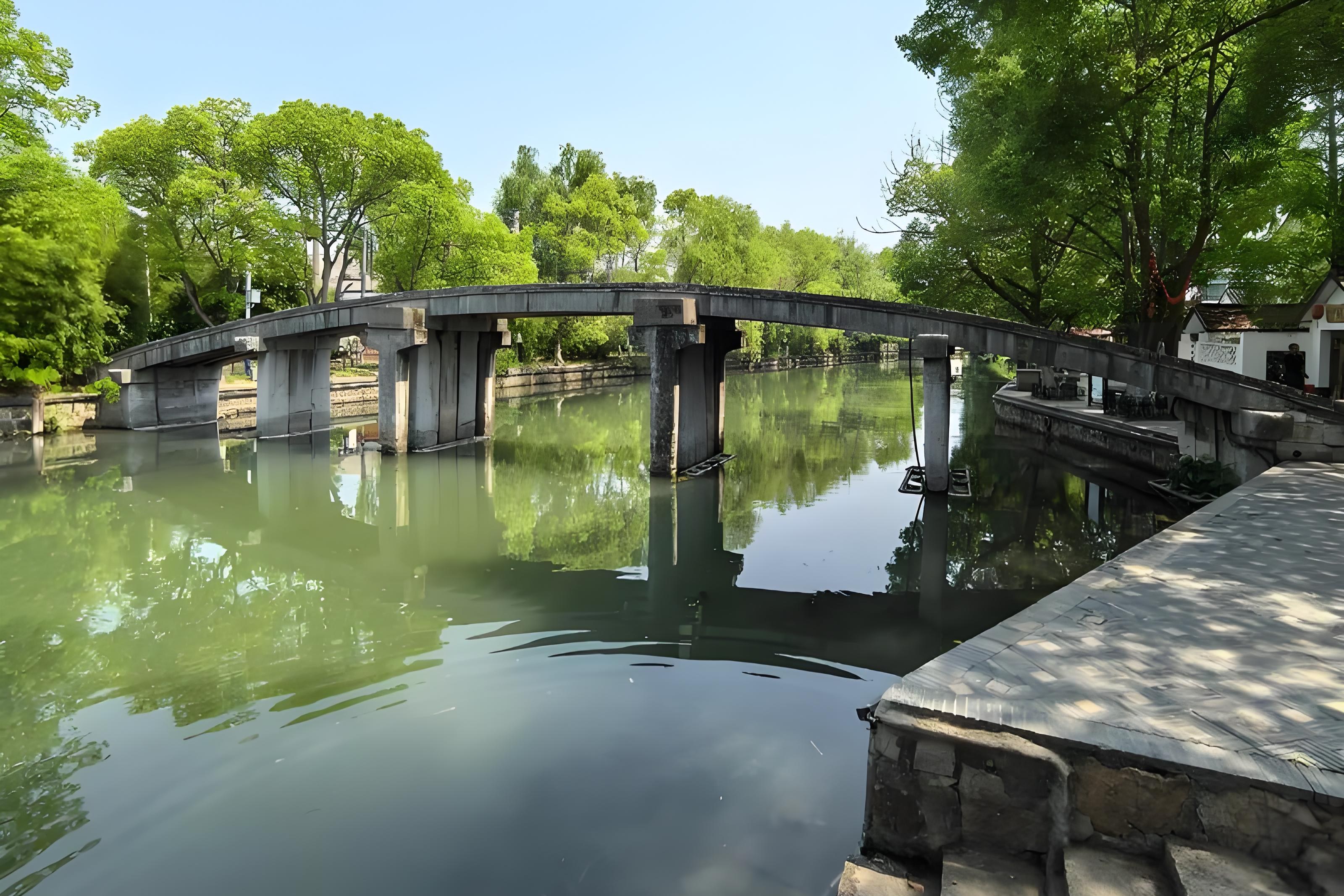 Photo of Dianshan Lake with a bridge and water-town rooftops