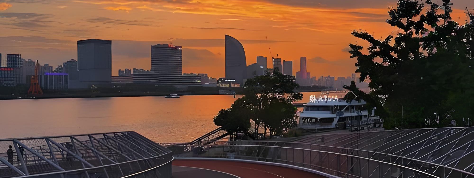 Photograph of the Huangpu Riverside Greenway's promenade with the Lujiazui skyline across the river
