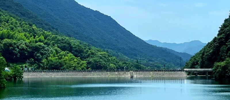 Dayangwu Reservoir with surrounding forested hills in Longwu