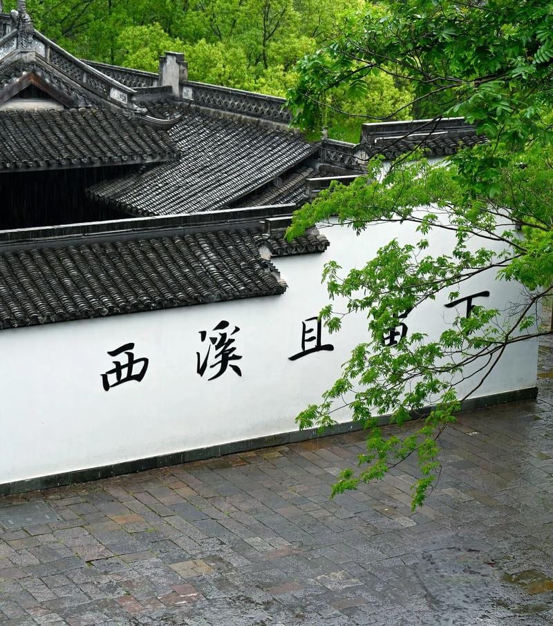 Traditional waterside buildings reflected in the calm green water of Xixi Wetland on a bright summer day